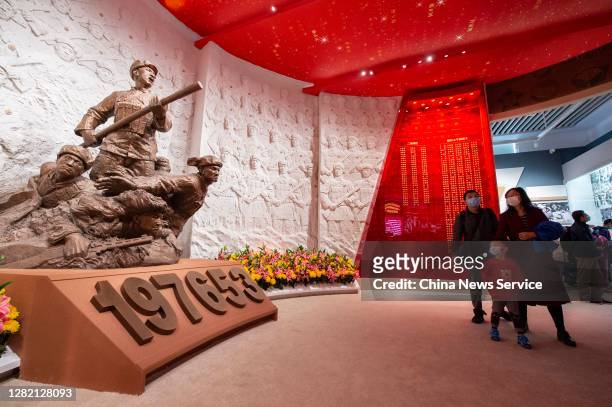 People watch an exhibition commemorating the 70th anniversary of the Chinese People's Volunteers army entering the Democratic People's Republic of...