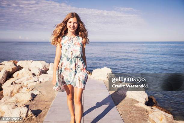 girl doing catwalk while walking on sidewalk during sunny day - kids catwalk stock pictures, royalty-free photos & images