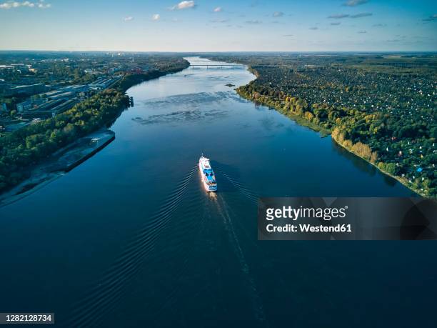 ship moving on volga river against sky - volga stock-fotos und bilder