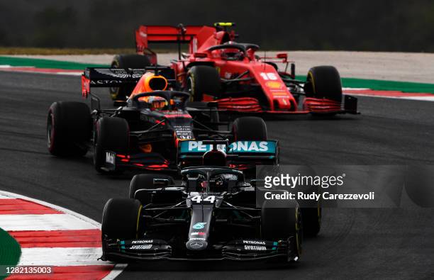 Lewis Hamilton of Great Britain driving the Mercedes AMG Petronas F1 Team Mercedes W11 leads Max Verstappen of the Netherlands driving the Aston...