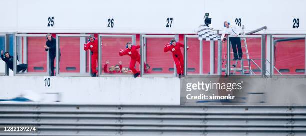 pit crew members at pit stop - pit stop stock pictures, royalty-free photos & images