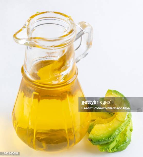 avocado oil and slices, studio shot - avocado oil on white stock pictures, royalty-free photos & images