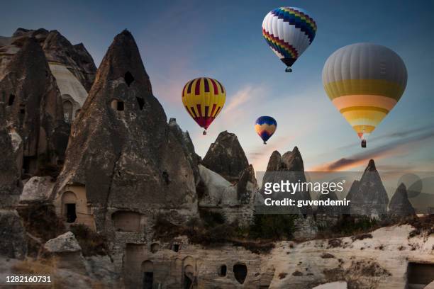 colorful hot air balloons flying over cappadocia in the morning - hot air balloon ride stock pictures, royalty-free photos & images
