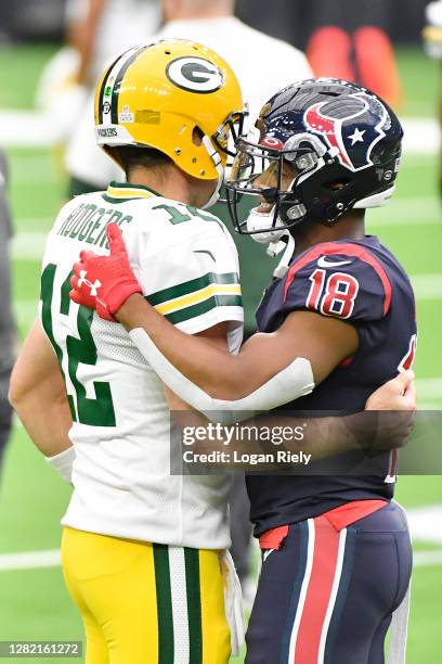 Aaron Rodgers of the Green Bay Packers greets former teammate Randall Cobb of the Houston Texans prior to the game at NRG Stadium on October 25, 2020...