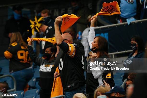 Fans of the Pittsburgh Steelers wave terrible towels prior to a game against the Tennessee Titans at Nissan Stadium on October 25, 2020 in Nashville,...