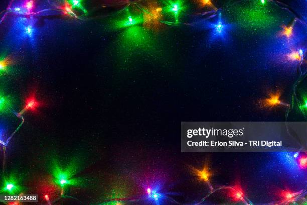 colorful frame with multicolored lights with copy space for a fun message - lichterkette dekoration stock-fotos und bilder