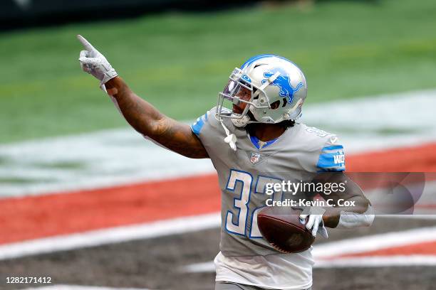 Andre Swift of the Detroit Lions celebrates his rushing touchdown against the Atlanta Falcons during the first half at Mercedes-Benz Stadium on...