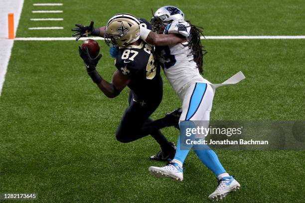 Jared Cook of the New Orleans Saints catches a touchdown pass while being guarded by Tre Boston of the Carolina Panthers in the first quarter at the...