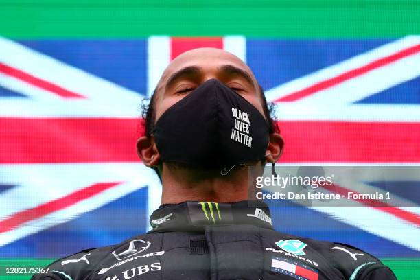 Race winner Lewis Hamilton of Great Britain and Mercedes GP celebrates his record breaking 92nd race win on the podium during the F1 Grand Prix of...