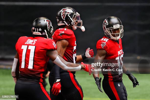 Calvin Ridley of the Atlanta Falcons is congratulated by Julio Jones and Todd Gurley II after catching a touchdown reception against the Detroit...