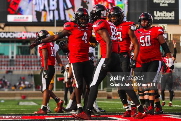 Receiver Trey Cleveland of the Texas Tech Red Raiders celebrates with SaRodorick Thopson after scoring a touchdown during the first half of the...