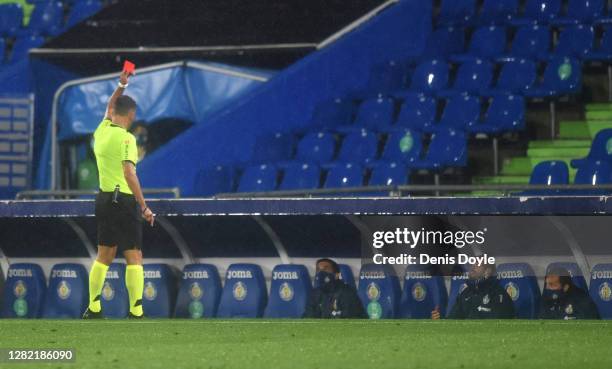 Member of the Getafe CF staff is shown a red card by the Match Referee Jesus Gil Manzano during the La Liga Santander match between Getafe CF and...