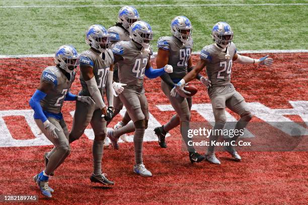 Trey Flowers of the Detroit Lions celebrates a fumble recovery with his teammates during the second half against the Atlanta Falcons at Mercedes-Benz...