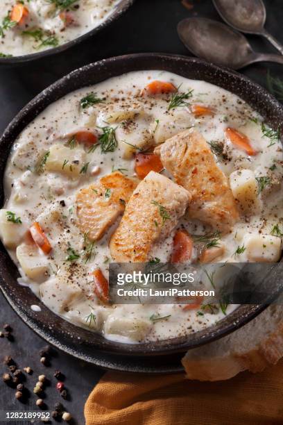 butter poached salmon chowder with potatoes, carrots and fresh dill - new england clam chowder stock pictures, royalty-free photos & images