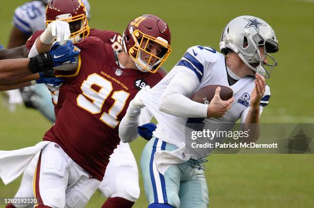 Ryan Kerrigan of the Washington Football Team sacks quarterback Ben DiNucci of the Dallas Cowboys in the fourth quarter of the game at FedExField on...