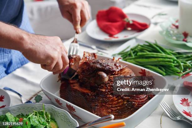 carving delicious honey glazed ham. ready for christmas at home! - glazed ham stock pictures, royalty-free photos & images