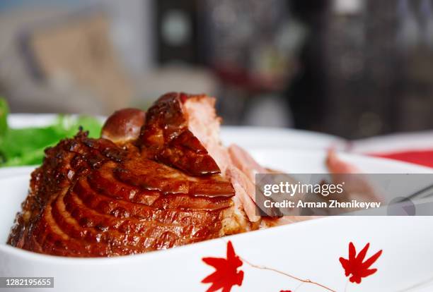 close-up of ready-to-eat honey glazed ham with a side of a salad on the dinner table. thanksgiving time! - glazed ham imagens e fotografias de stock