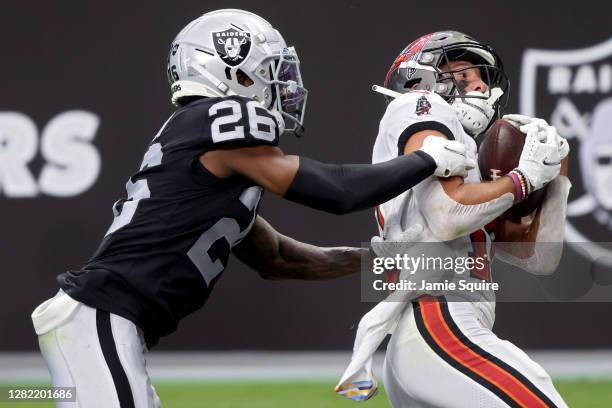 Scotty Miller of the Tampa Bay Buccaneers catches a touchdown pass while being guarded by Nevin Lawson of the Las Vegas Raiders in the second quarter...