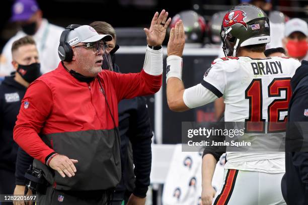 Head coach Bruce Arians and Tom Brady of the Tampa Bay Buccaneers celebrate after scoring a touchdown in the second quarter against the Las Vegas...