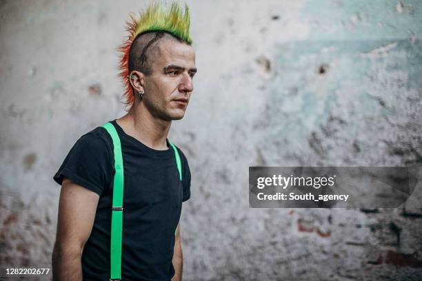 male punk person standing in abandoned building - traditional piercings stock pictures, royalty-free photos & images