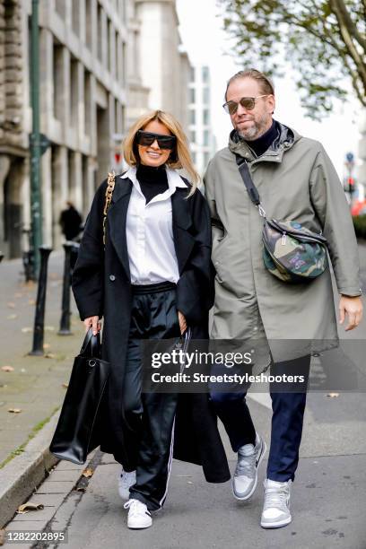 Influencer Gitta Banko, wearing a white blouse by Steffen Schraut, a black turtleneck pullover by Zara, a black oversize coat by Zara, jogging pants...