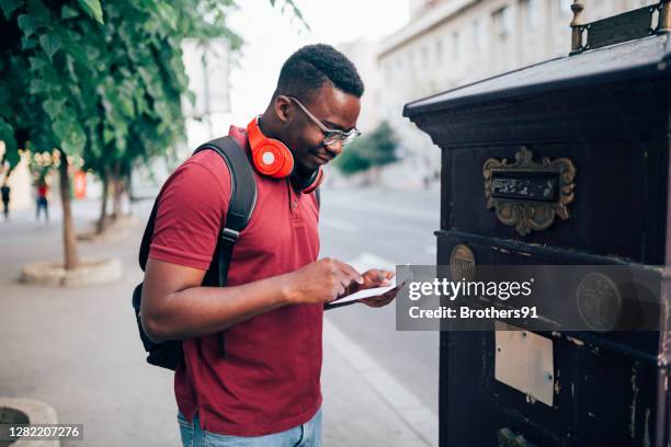 happy young african american voting by mail - choosing candidate stock pictures, royalty-free photos & images