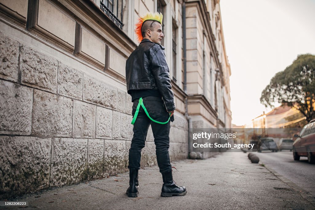 Young panker with colorful coiffure standing on the street