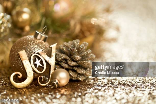 christmas gold ornaments background - joy stock pictures, royalty-free photos & images