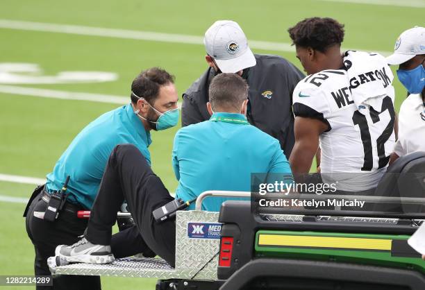 Dede Westbrook of the Jacksonville Jaguars is helped onto a cart to be driven off the field due to a knee injury at the end of the third quarter...