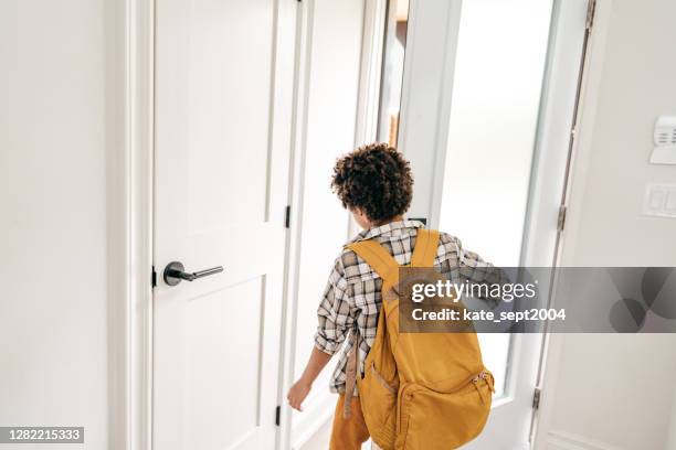 elementary age boy going to school with backpack. he is leaving his house - open backpack stock pictures, royalty-free photos & images