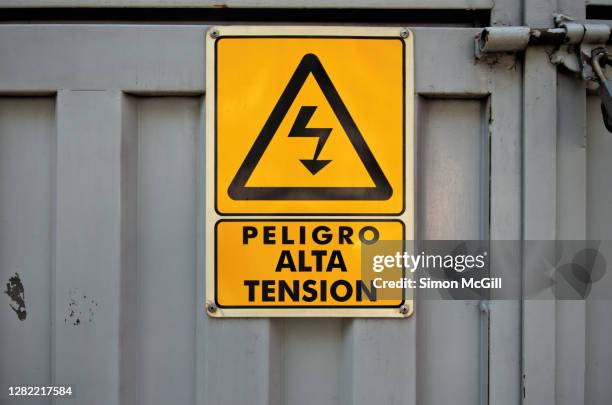 Spanishlanguage Warning Sign Stating Peligro Alta Tensin Danger High Voltage On A Metal Door High-Res Stock Photo