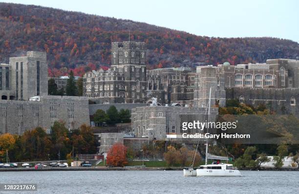 Boat sails in the Hudson River in front of the United States Military Academy, West Point on October 25, 2020 as seen from Garrison, New York.