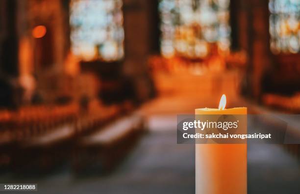 close-up of candle in the church - memorial service photos et images de collection
