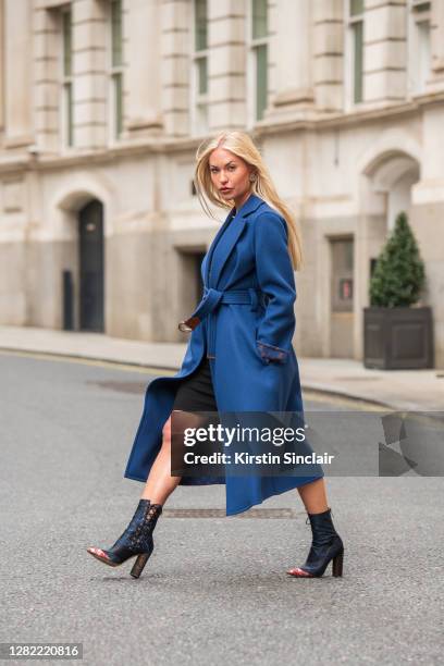 Influencer and model Lexi Fargo wears a Louis Vuitton coat, Orsay dress, Dior runway collection boots and Chanel earrings during LFW September 2020...