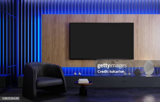 8k tv room modern minimalist living room with flat tv with led lights behind wall panel - home theater stock pictures, royalty-free photos & images
