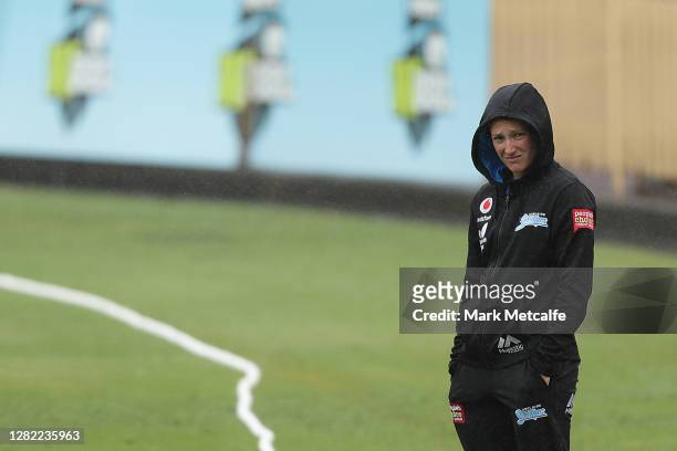 Megan Schutt of the Strikers inspects the pitch during a rain delay during the Women's Big Bash League WBBL match between the Sydney Sixers and the...