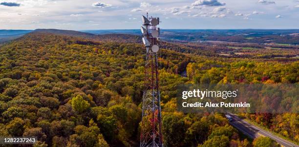 telecommunication cellular tower on a mountain ridge in the appalachian mountains in the fall. - 5g tower stock pictures, royalty-free photos & images