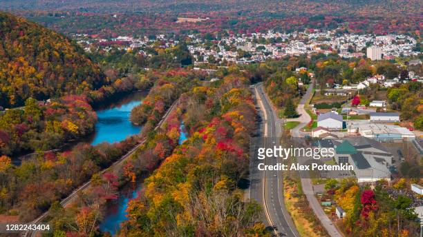 colorful fall in appalachian mountains, pennsylvania. the aerial remote view on lehighton over the small town parriville along with the lehigh river. - pennsylvania stock pictures, royalty-free photos & images