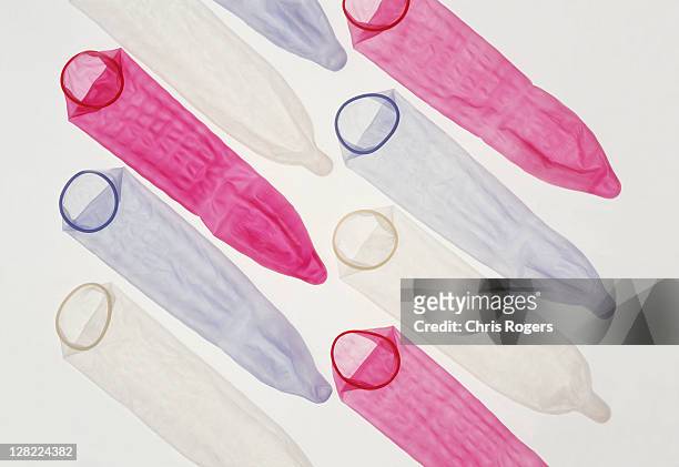 colored condoms - condon fotografías e imágenes de stock