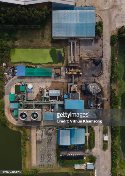 aerial top view biomass power plant industry zone, include cooling tower steam boiler conveyor and fuel wood chip storage, pipeline and stack, electricity power plant drone view, oil and gas - carbon cycle stock-fotos und bilder