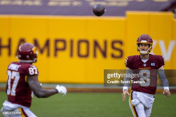 Kyle Allen of the Washington Football Team completes a pass to Jeremy Sprinkle against the Dallas Cowboys during the second half at FedExField on...