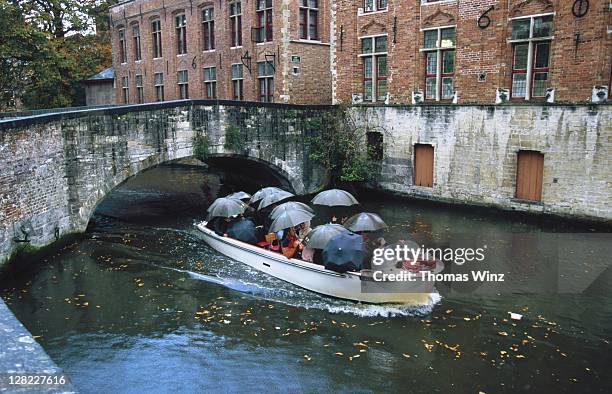 belgium, brugge, rainy city tour via boat - funny tourist stock pictures, royalty-free photos & images