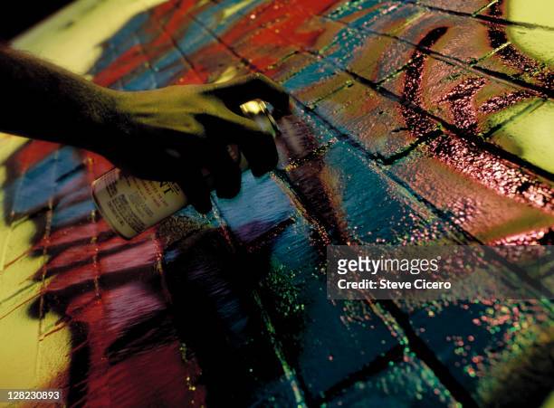 graffiti artist spraying brick wall - graffiti on brick wall stock-fotos und bilder