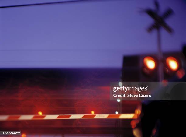 crossing gate along railroad at night with stopped vehicle - level crossing stock pictures, royalty-free photos & images