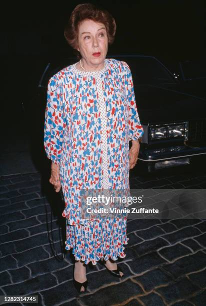 Canadian-born American actress Fay Wray wearing a full-length red, white and blue dress to an event, location unknown, circa 1985.