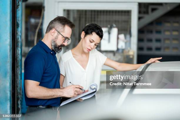 car insurance claims. insurance adjuster explaining damage of car exterior to customer at auto repair center. business hour 24/7 service coverage. customer service, quality of service. - car accident report stock pictures, royalty-free photos & images