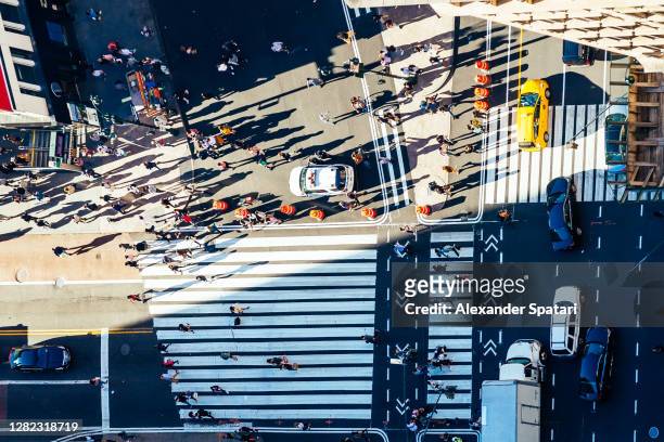 directly above aerial view of people walking on the street in new york, usa - manhattan stock-fotos und bilder