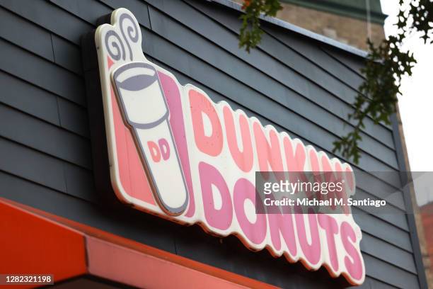 Dunkin' storefront sign is seen on October 26, 2020 in New York City. The Dunkin’ Brands, the parent company of the Dunkin’ and Baskin Robbins...