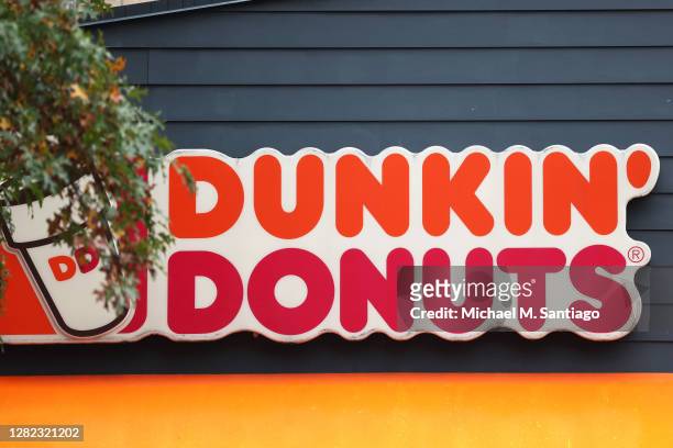 Dunkin' storefront sign is seen on October 26, 2020 in New York City. The Dunkin’ Brands, the parent company of the Dunkin’ and Baskin Robbins...