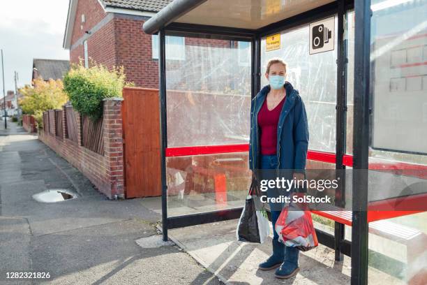 waiting for the bus - bus shelter stock pictures, royalty-free photos & images